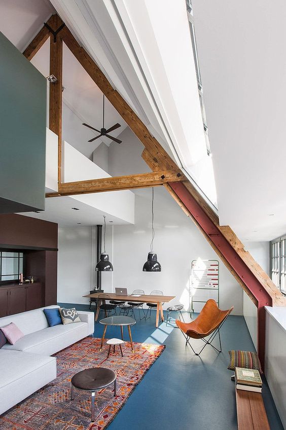 loft moderne avec charpente en bois et grand tapis dans le salon
