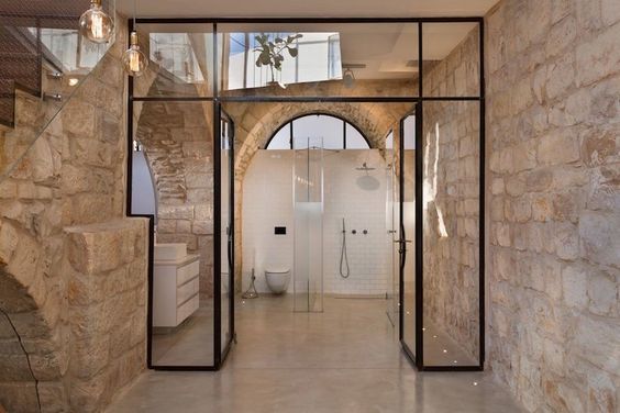 une salle de bains chic avec matériaux de qualité et murs en pierre