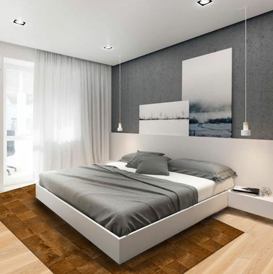 linge de lit gris au dessus d'un lit blanc dans une chambre monochromatique