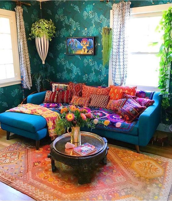 coussins de couleurs vives sur un canapé bleu dans un salon