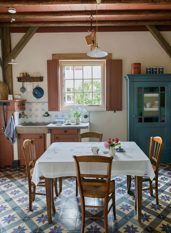 déco méditerranéenne dans une cuisine rustique avec mobilier vintage en bois et carrelage bleu au sol