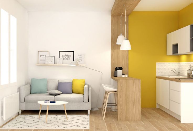 Aménager un studio en peignant les murs de couleurs différentes pour délimiter les différents espaces : jaune côté cuisine et blanc côté salon