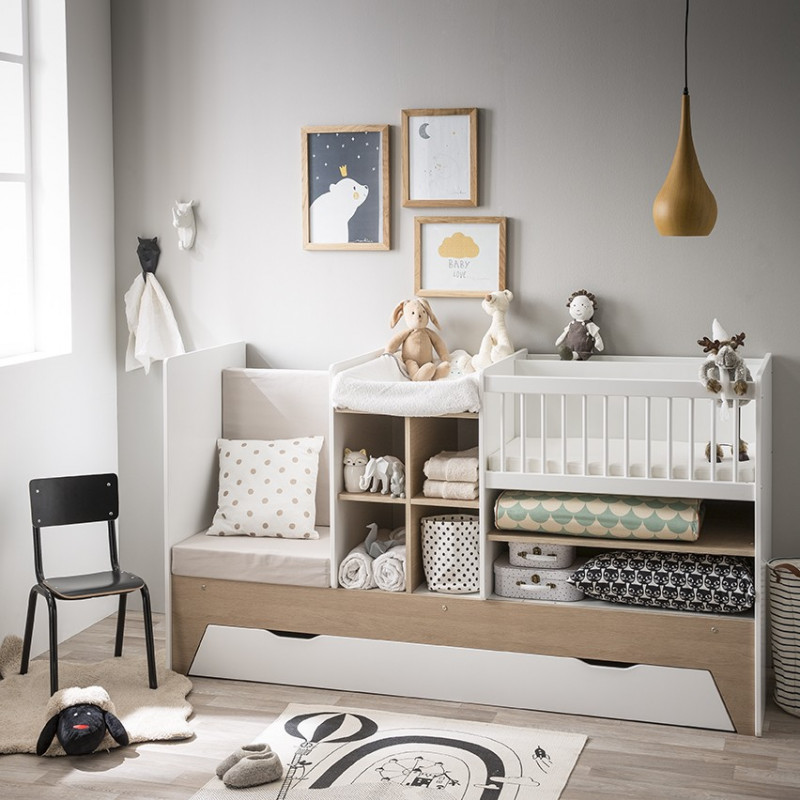 Aménager petite chambre bébé avec un lit compact, tout-en-un, avec table à langer, étagères et petit fauteuil