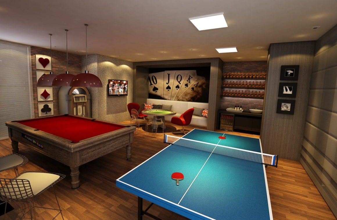 Une salle de jeux aménagé dans le sous-sol avec un billard et un table de ping-pong