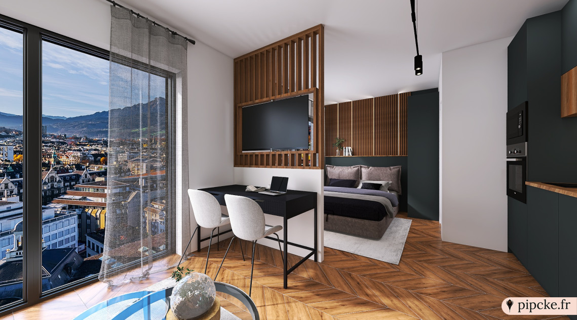 studio moderne avec un coin bureau avec des chaises, un lit confortable, un espace de rangement élégant, un téléviseur mural et une cuisine intégrée.