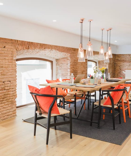Une rénovation appartement ancien réalisée avec beaucoup de goût, dans cette grande pièce salle à manger, avec des murs en briques