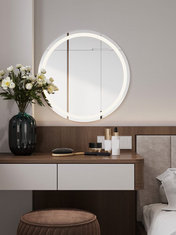Un coin chambre moderne avec coiffeuse en bois, miroir rond lumineux, tabouret marron, fleurs blanches, et coussin gris clair.