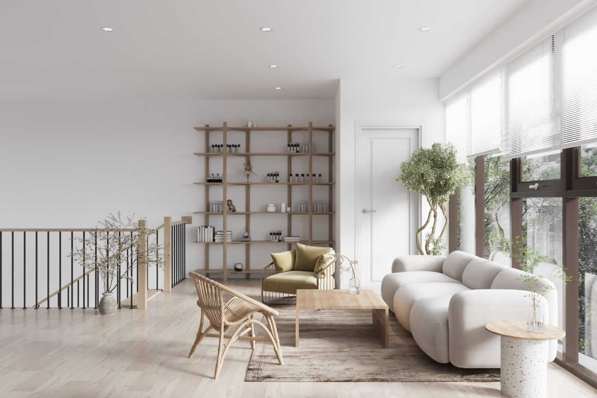 Salon incluant canapé blanc, fauteuils en rotin, étagère en bois et plantes.