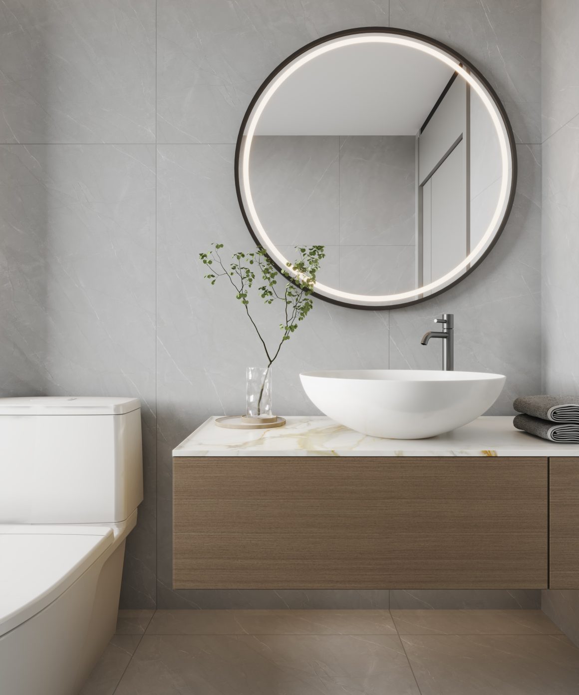 WC avec vasque blanche, meuble en bois clair et miroir rond.