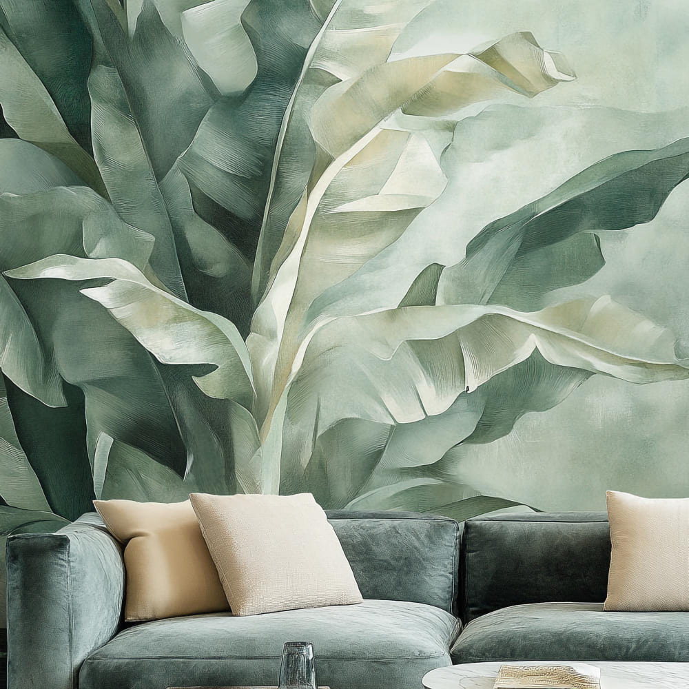 de grandes feuilles tropicales ornent la tapisserie, derrière un canapé vert et beige