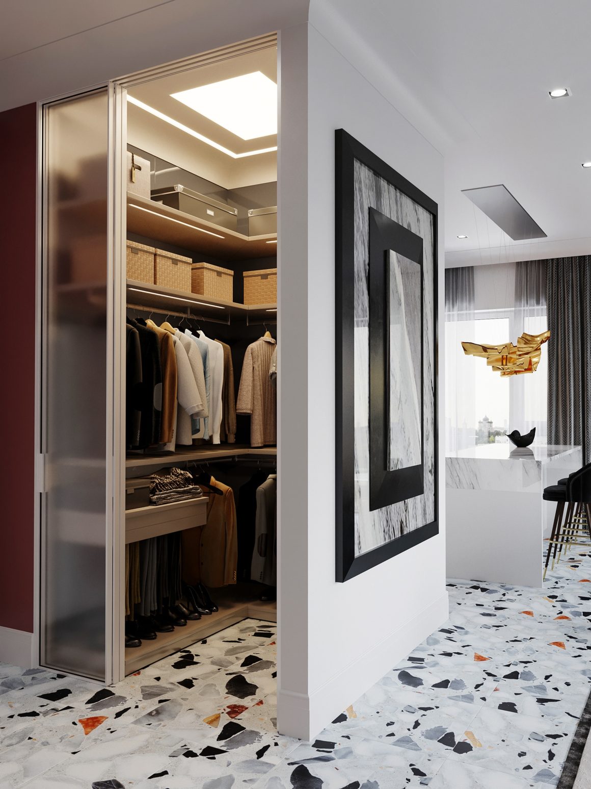 Un petit dressing incluant des étagères, paniers, vêtements suspendus, éclairage chaleureux et sol en terrazzo coloré.