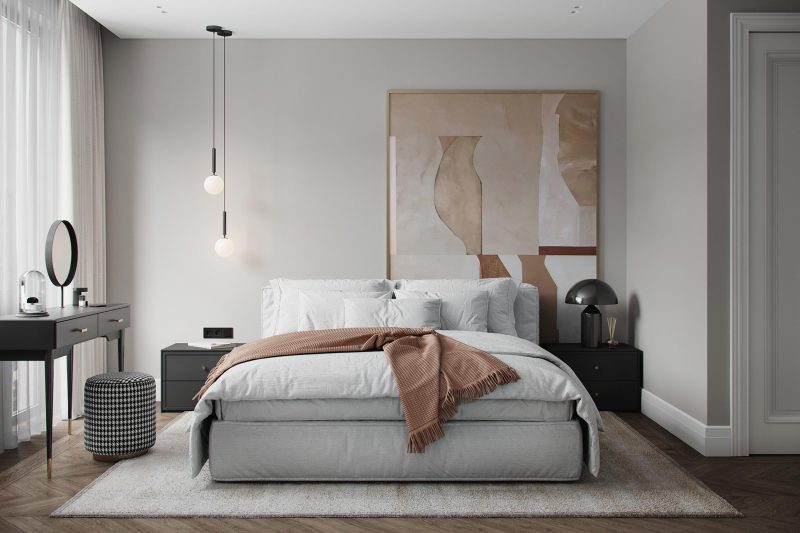 Chambre aux tons neutres incluant lit cosy, table de chevet noire et œuvre murale abstraite