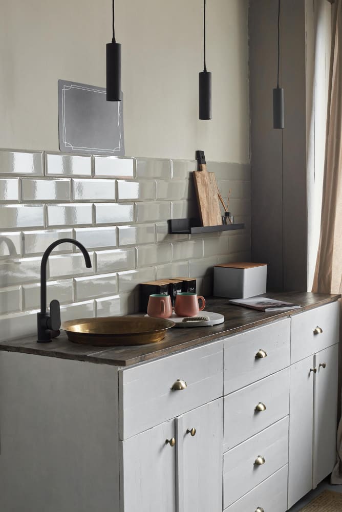 la tendance couleur mur cuisine met ici en avant la couleur gris perle, avec du carrelage métro sur la crédence, et un évier style ancien