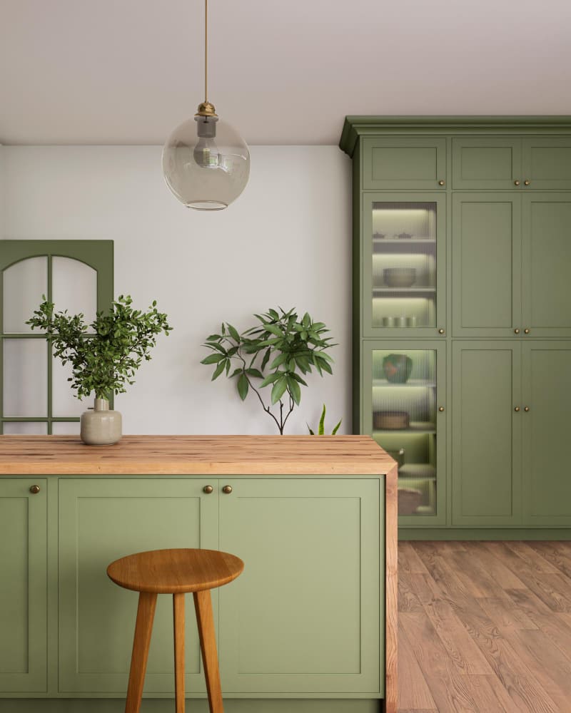 la tendance couleur mur cuisine tourne ici au vert sauge, avec un plan de travail en bois clair