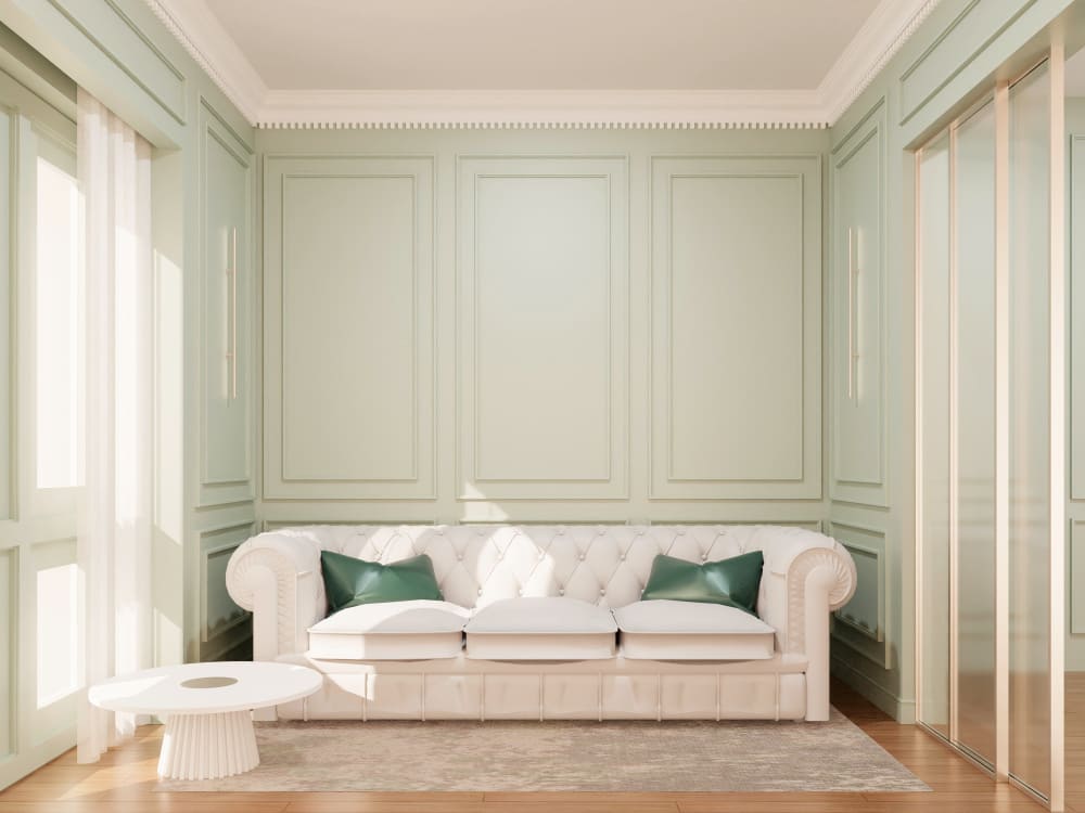 tendances déco avec un canapé dans une grande pièce avec du parquet dans le style haussmannien et des moulures vert d'eau