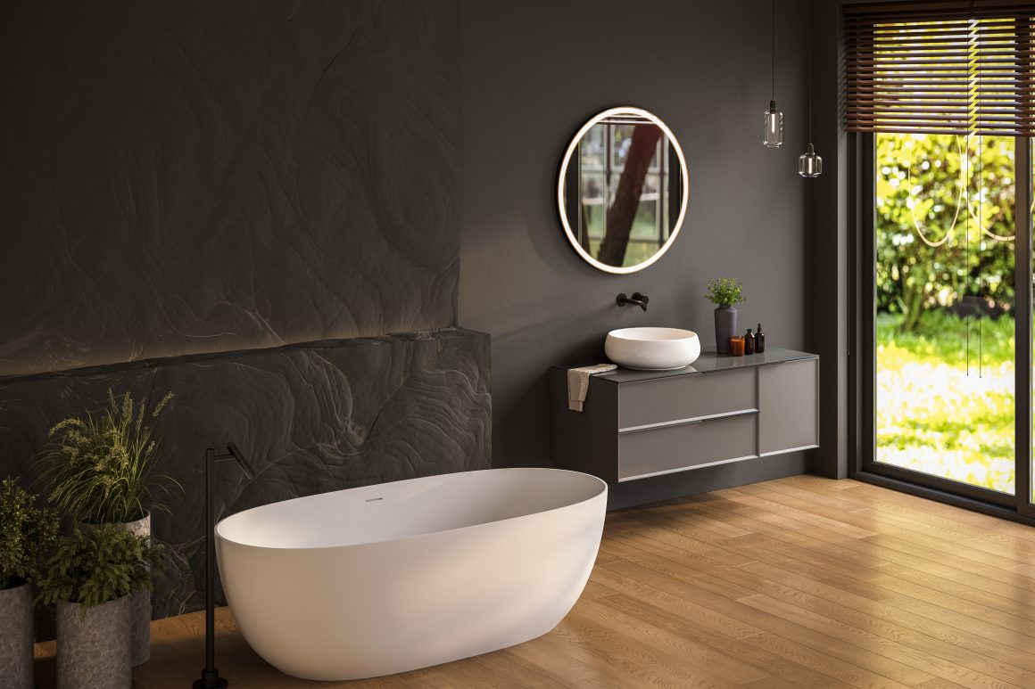 Salle de bains avec baignoire îlot blanche, meuble vasque, grandes baies vitrées et plantes