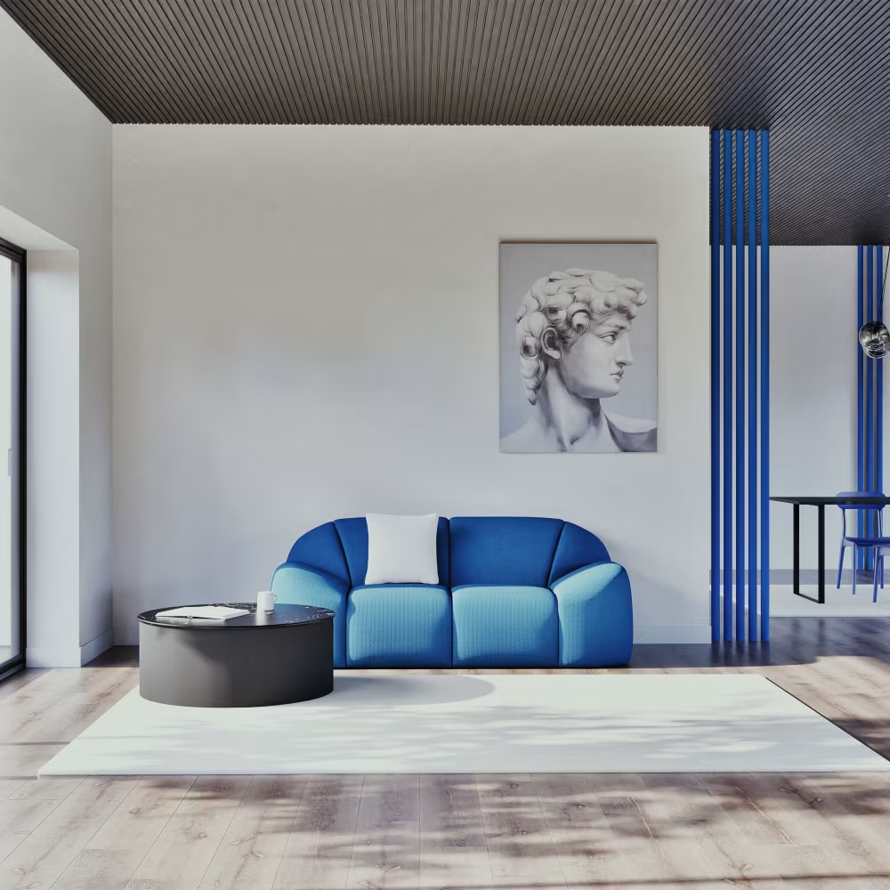 Espace lumineux aménagé avec canapé bleu, table basse ronde noire et grande toile classique
