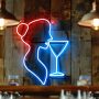 Gros plan sur un néon bar représentant une silhouette féminine et un verre à cocktail, fixé sur un mur en lattes de pin