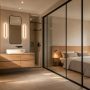 Salle de bain ouverte sur chambre avec cloison vitrée, meuble bois clair et douche noire encastrée